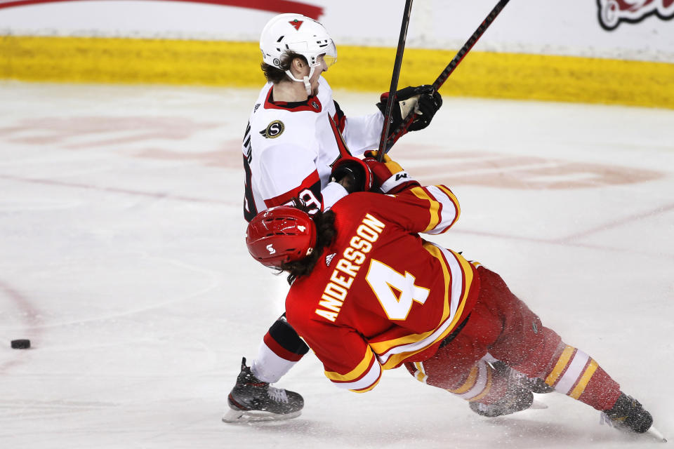 Ottawa Senators' Alex Formenton, top, collides with Calgary Flames' Rasmus Andersson during the second period of an NHL hockey game Sunday, May 9, 2021, in Calgary, Alberta. (Larry MacDougal/The Canadian Press via AP