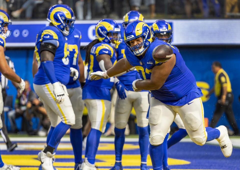 The Rams' Steve Avila spikes the ball in celebration of Tutu Atwell's second-quarter touchdown against Pittsburgh.