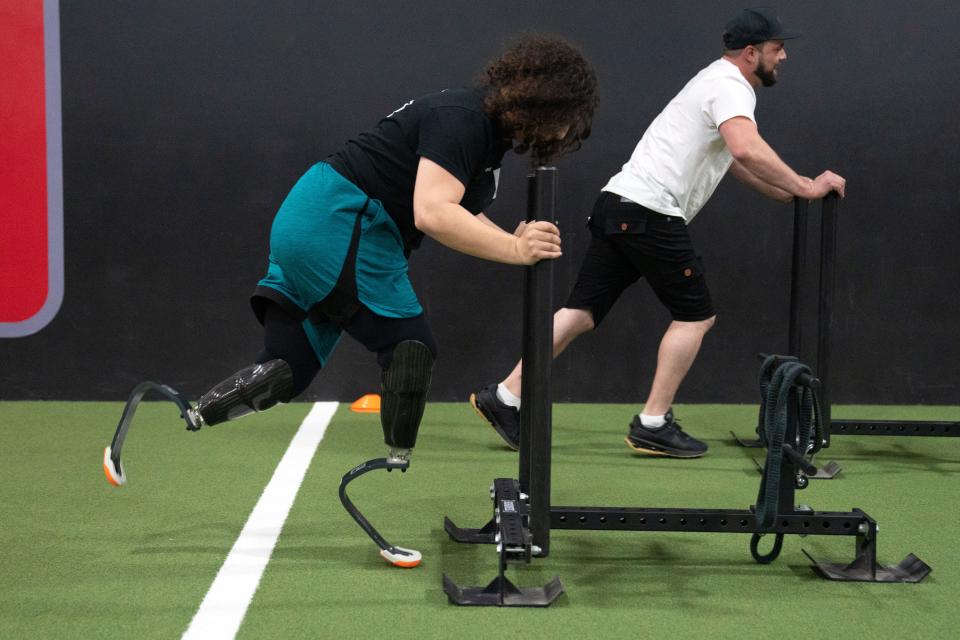 Double amputee Taylor Layle pushes a sled during Levitate's Freedom Tour Test Run at D1 Training Bergen County in Upper Saddle River on Saturday, April 22, 2023.