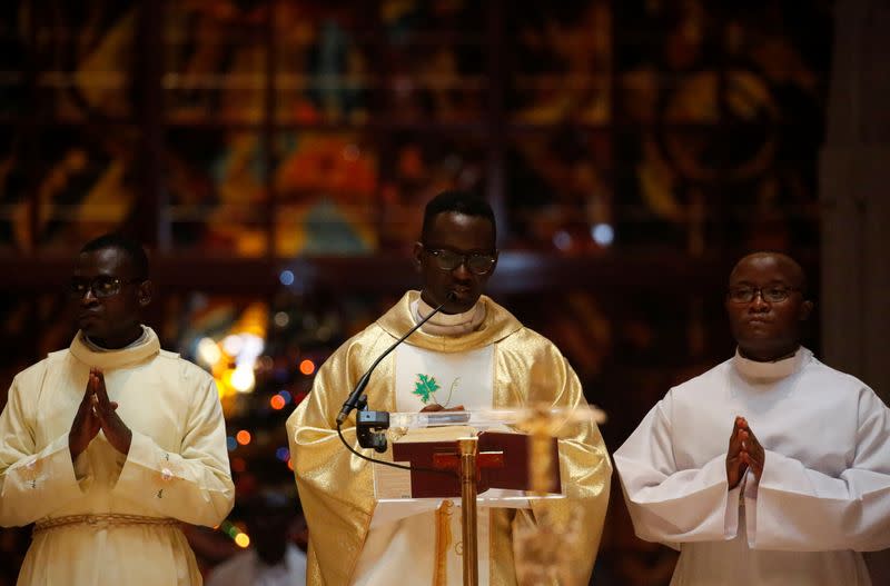 Franck Allatin, priest and rector of the Basilica Notre Dame leads a Christmas mass in Yamoussoukro