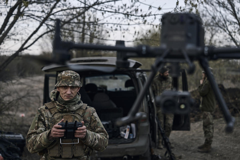 FILE - A Ukrainian soldier launches a drone in the area of the heaviest battles with Russian troops in Bakhmut, Donetsk region, Ukraine, Sunday, April 9, 2023. Ukrainian government is launching a new initiative meant to streamline and promote innovation on drones and other technologies that have become critical in the country's fight against Russia, by bringing together state, military, and private sector developers working on defense issues. (AP Photo/Libkos, File)