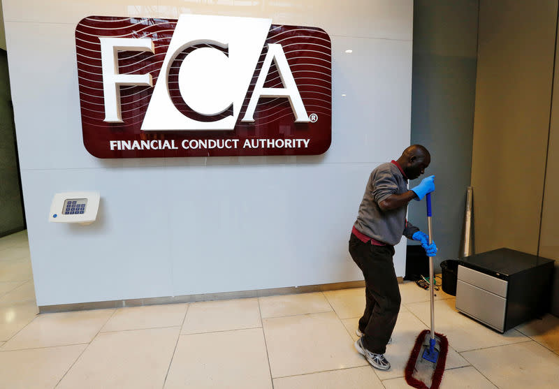 FILE PHOTO: A maintenance worker cleans the entrance area of the headquarters of the new Financial Conduct Authority (FCA) in the Canary Wharf business district of London April 1, 2013. REUTERS/Chris Helgren