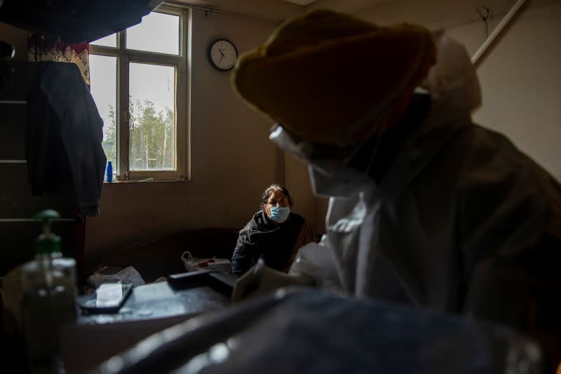 Jitender Singh Shunty from the Shaheed Bhagat Singh Sewa Dal prepares the papers before taking the body of a 57-year-old coronavirus disease (COVID-19) victim for the cremation in New Delhi