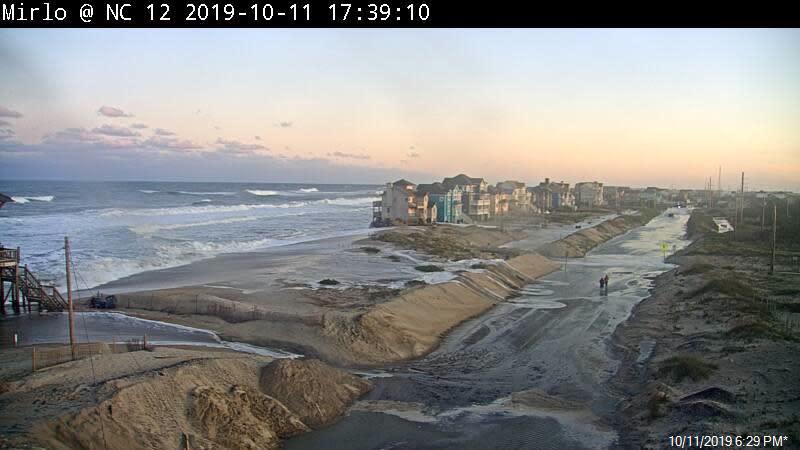 A view of an overwashed N.C. 12 with Rodanthe in the background. The DOT has built a new bridge that now bypasses this section of erosion-prone beachfront.