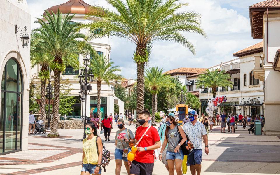 Masked-up visitors at Walt Disney World Resort, Florida - Getty