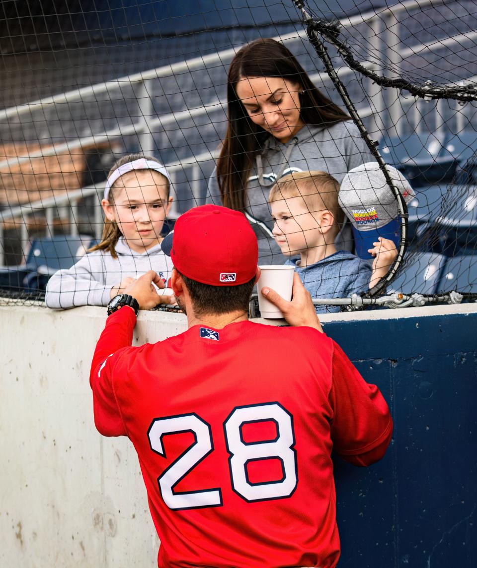 WooSox manager Chad Tracy talks with his kids and wife prior to a game at Polar Park in April.