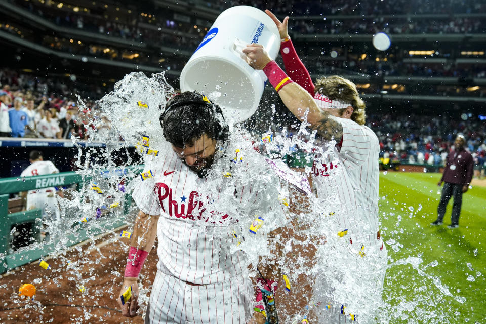 Philadelphia Phillies' Kyle Schwarber, front left, is doused by teammates Bryson Stott, right, and Brandon Marsh, back left, after a baseball game against the Los Angeles Dodgers, Friday, June 9, 2023, in Philadelphia. (AP Photo/Matt Rourke)