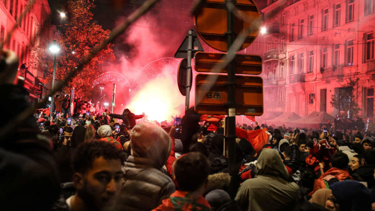 Moroccan supporters celebrate Morocco's victory in the Qatar 2022 World Cup quarter-final football match against Portugal in Brussels on December 10, 2022. (Photo by Valeria Mongelli / AFP)