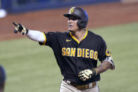 San Diego Padres' Manny Machado reacts after hitting a solo home run during the fourth inning of a baseball game against the Miami Marlins, Sunday, July 25, 2021, in Miami. (AP Photo/Lynne Sladky)