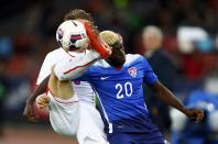 Silvan Widmer of Switzerland fights for the ball with Gyast Zardes of the U.S (R) during their international friendly soccer match at the Letzigrund Stadium in Zurich March 31, 2015. REUTERS/Arnd Wiegmann