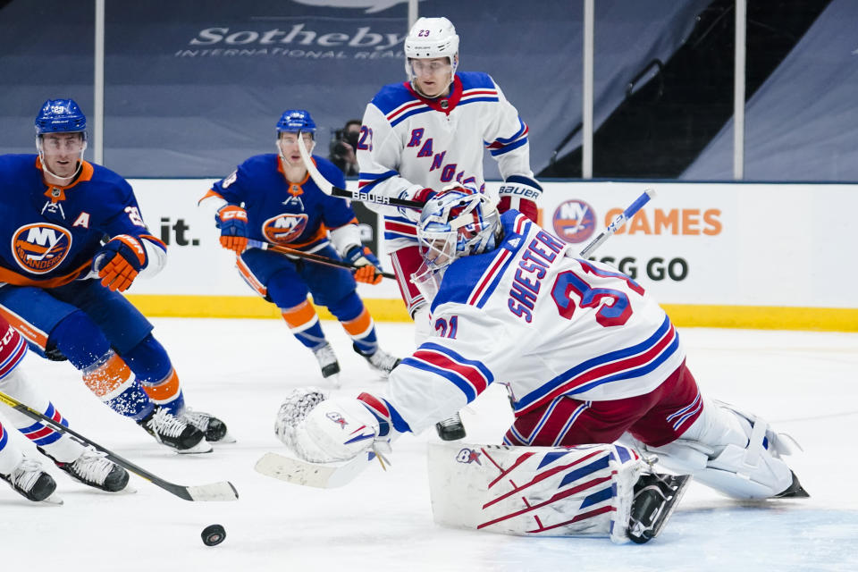 New York Rangers goaltender Igor Shesterkin (31) reaches for the puck during the second period of an NHL hockey game against the New York Islanders Sunday, April 11, 2021, in Uniondale, N.Y. (AP Photo/Frank Franklin II)