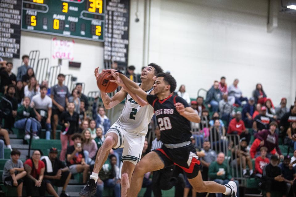 West Oso's Brandon Simmons blocks a shot by King's Terrell Palmer during the game Tuesday, Nov. 30, 2021, at King High School.