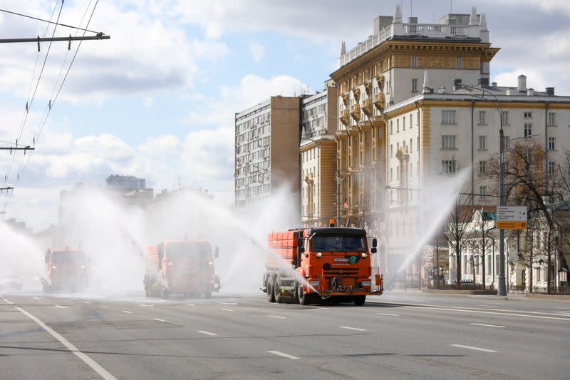 Vehicles spray disinfectant while sanitizing a road to prevent the spread of the coronavirus disease in Moscow