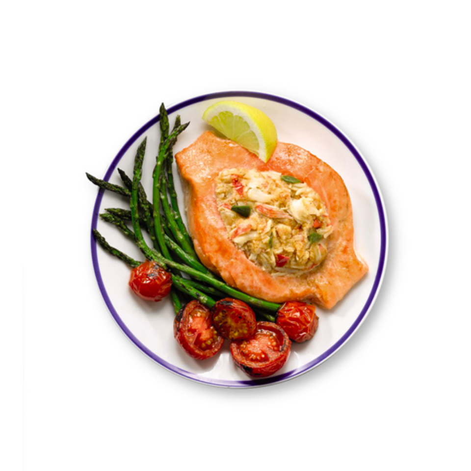 stuffed salmon on a white plate with veggies