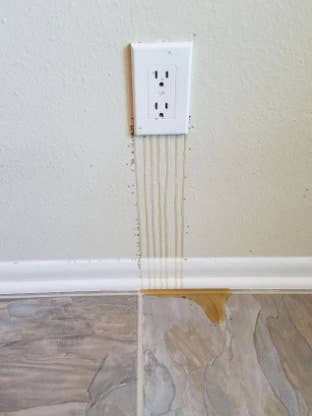 honey dripping from the outlet on a wall