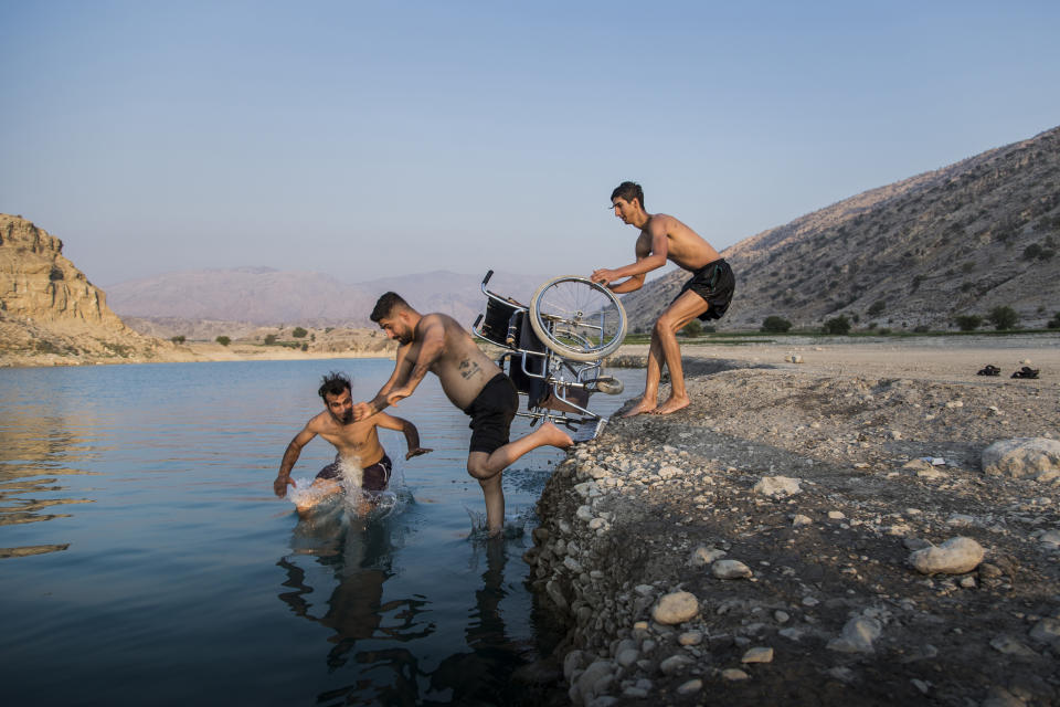 In this image released by World Press Photo, Thursday April 15, 2021, by Fereshteh Eslahi, Podium Photos, titled Thoughts of Flight, part of a series which won third prize in the Sports Stories category, shows Saeed Ramin, a professional traceur (practitioner of parkour) enjoys time with friends at Kosar Dam Lake, near Gachsaran, Iran, on Sept. 9, 2020. (Fereshteh Eslahi, Podium Photos, World Press Photo via AP)