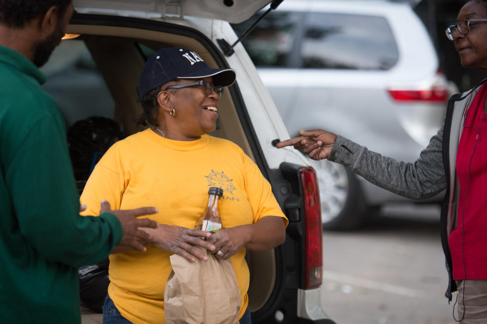 Kat "Mama Kat" Daniels passes out dinner to homeless citizens.