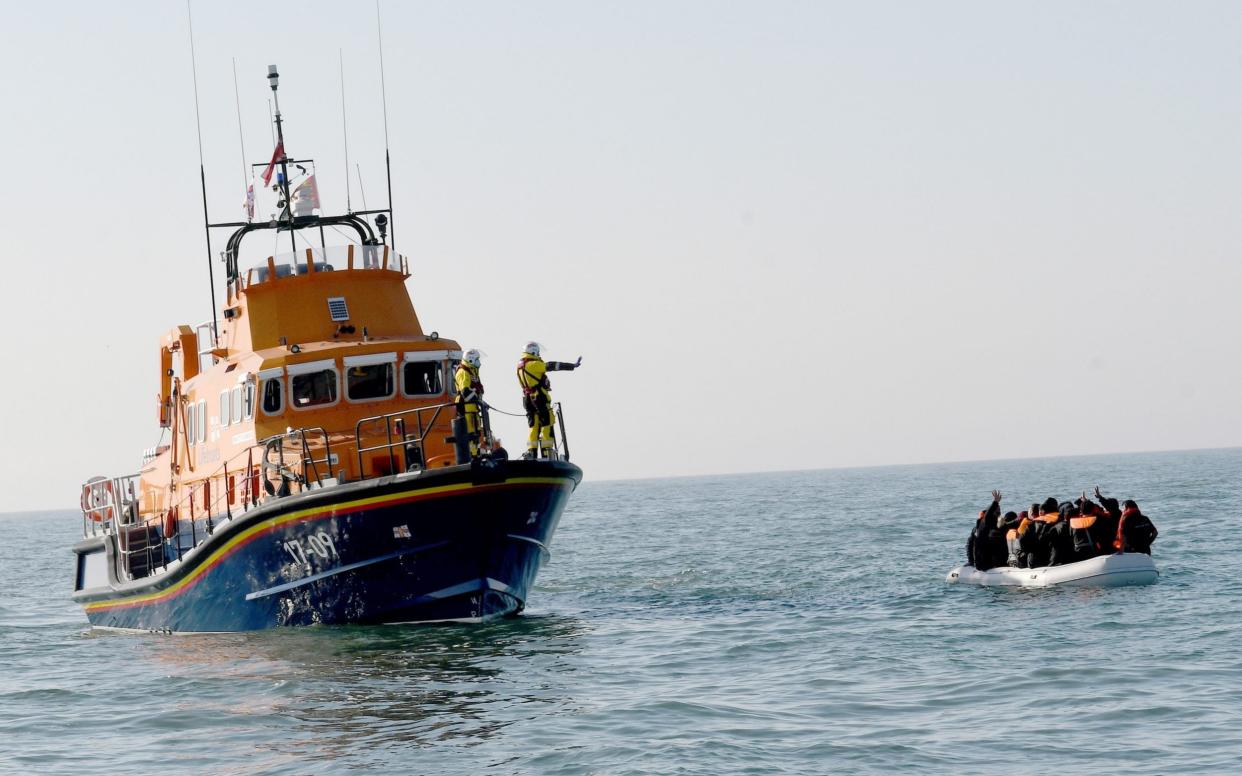 Migrant boat and life boat - STEVE FINN 