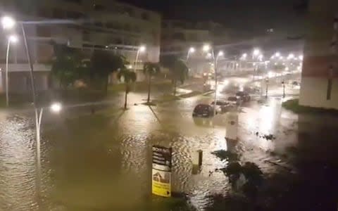Cars underwater in flooded streets in Pointe-a-Pitre, Guadeloupe - Credit: YVES THOLE/AFP