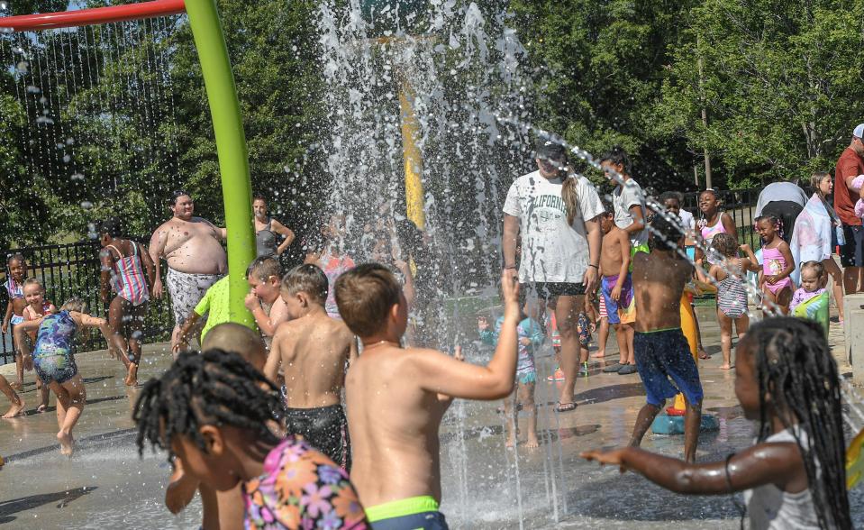 Children with parents cool off in water at the KidVenture2 splash pad at the Anderson Sports and Entertainment Complex in Anderson, S.C. Friday, June 21, 2024.