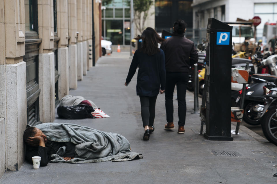 People walk by homeless people sleeping on the streets of San Francisco, California -- Aug. 23, 2018. (Photo: The Washington Post via Getty Images)