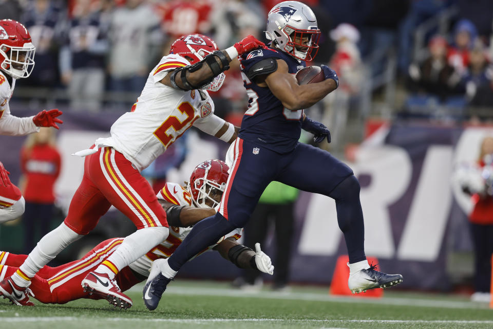 New England Patriots running back Kevin Harris (36) eludes the grip of Kansas City Chiefs safety Mike Edwards (21) as he runs for a touchdown during the second half of an NFL football game, Sunday, Dec. 17, 2023, in Foxborough, Mass. (AP Photo/Michael Dwyer)