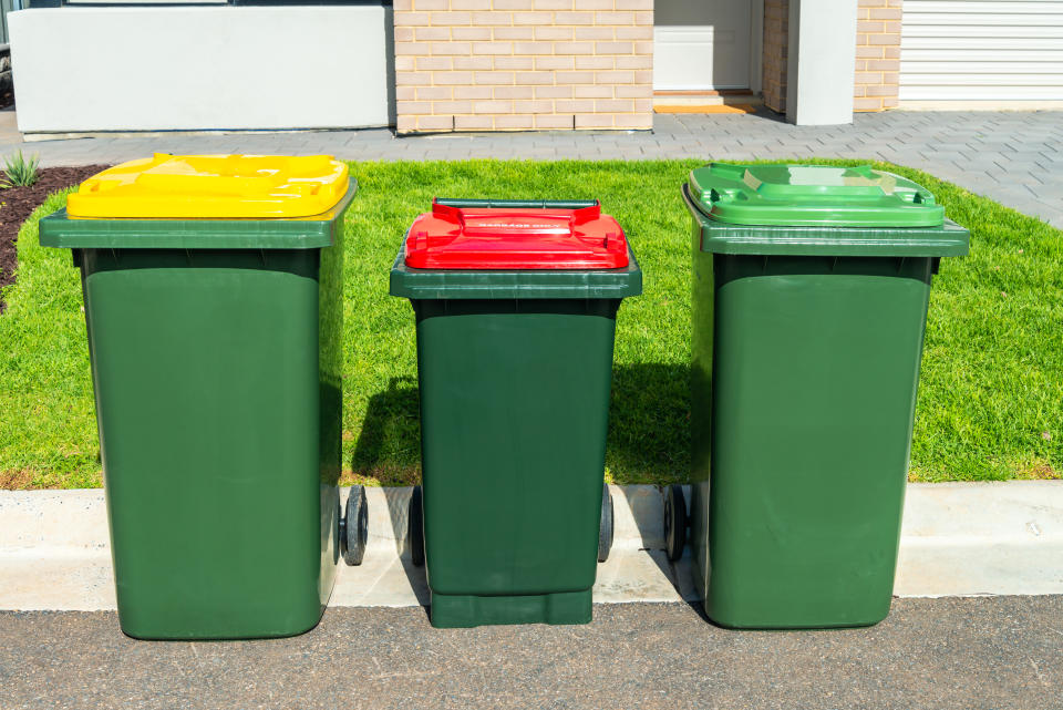 Australian wheelie bins with colourful lids for organic, general waste, and recycling products provided by local city council