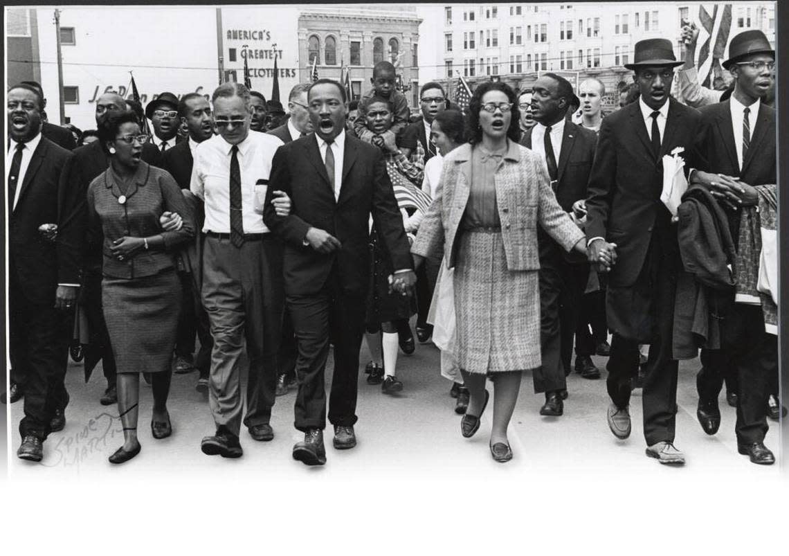 Dr. Martin Luther King Jr. joins with wife Coretta and supporters in 1965 to push for voting rights for African-Americans during the historic march from Selma to Montgomery in Alabama.