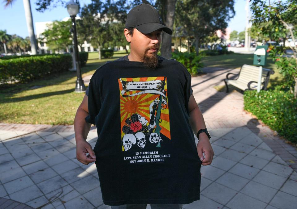 U.S. Marine Corps veteran Sgt. Billy Olswicki displays one of his T-shirts from his service, ‘In memoriam LCPL Sean Allen Crockett, SGT John K. Rankel’, while at Memorial Park on Wednesday, Nov. 1. 2023, in Stuart.