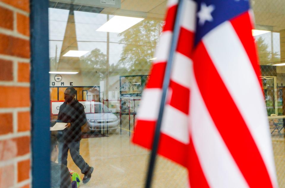 A voter walks to submit their ballot inside the Iroquois High School polling precinct during the 2023 Primary voting Tuesday in Louisville, Ky. May 16, 2023.