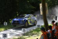 <p>The rally stage at Goodwood isn't nearly as well known as the hill-climb, but it's just as much fun to watch—if not more so. We spent hours gazing at rally-prepped cars new and old, from old Saabs to World Rally Championship cars to even <a href="https://www.caranddriver.com/news/a25016780/jaguar-f-type-convertible-rally-car/" rel="nofollow noopener" target="_blank" data-ylk="slk:a Jaguar F-type rally car;elm:context_link;itc:0;sec:content-canvas" class="link ">a Jaguar F-type rally car</a>, running through the woods. We were even lucky enough to snag a ride in Subaru's STI rally car running in the American Rally open class, piloted by none other than Oliver Solberg, the 17-year-old son of world champion Petter Solberg.</p>
