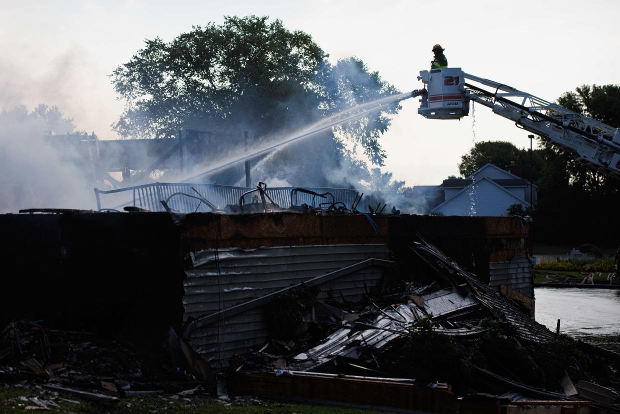 Firefighters work to put out a fire at the Juday Creek Golf Course clubhouse on Monday, Aug. 26, 2024, in Granger.