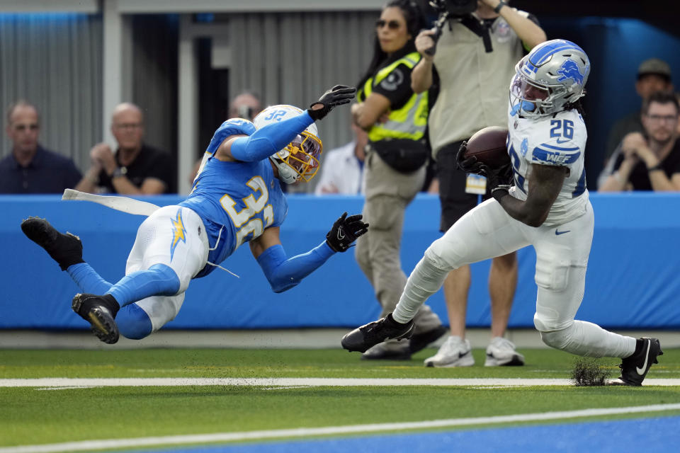 Detroit Lions running back Jahmyr Gibbs (26) makes a catch in front of Los Angeles Chargers safety Alohi Gilman (32) during the first half an NFL football game Sunday, Nov. 12, 2023, in Inglewood, Calif. (AP Photo/Ashley Landis)