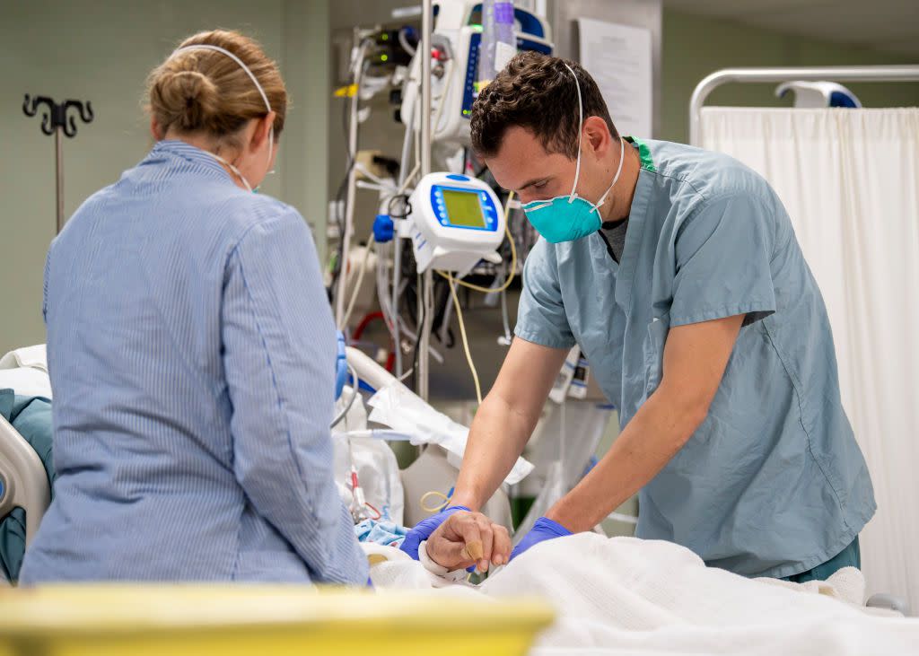 U.S. Navy,  Lt. Wade Miller treats a patient aboard the hospital ship USNS Mercy on April 4, 2020.