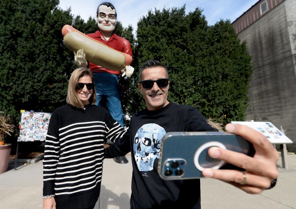 Oscar Bolorino, right, of Barcelona, Spain, snaps a selfie of himself and Rachell Requena, also of Barcelona, in front of the Hot Dog Man statute that has stood on Arch Street in Atlanta, Illinois, for the past 20 years. Down Arch Street, the American Giants Museum had a soft opening earlier this summer with a grand opening slated for May 2024.