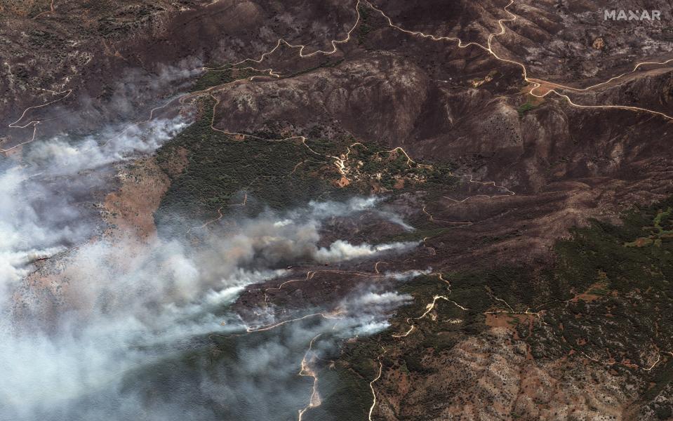 This image provided by Maxar Technologies, shows wildfires on the island of Corfu, Greece, Tuesday July 25, 2023. A third successive heat wave in Greece pushed temperatures back above 40 degrees Celsius (104 degrees Fahrenheit) across parts of the country Tuesday amid a string of evacuations from fires that have raged out of control for days. A fire service spokesman said the worst blazes were on the southeastern island of Rhodes and the northwestern island of Corfu. (Satellite image ©2023 Maxar Technologies via AP)