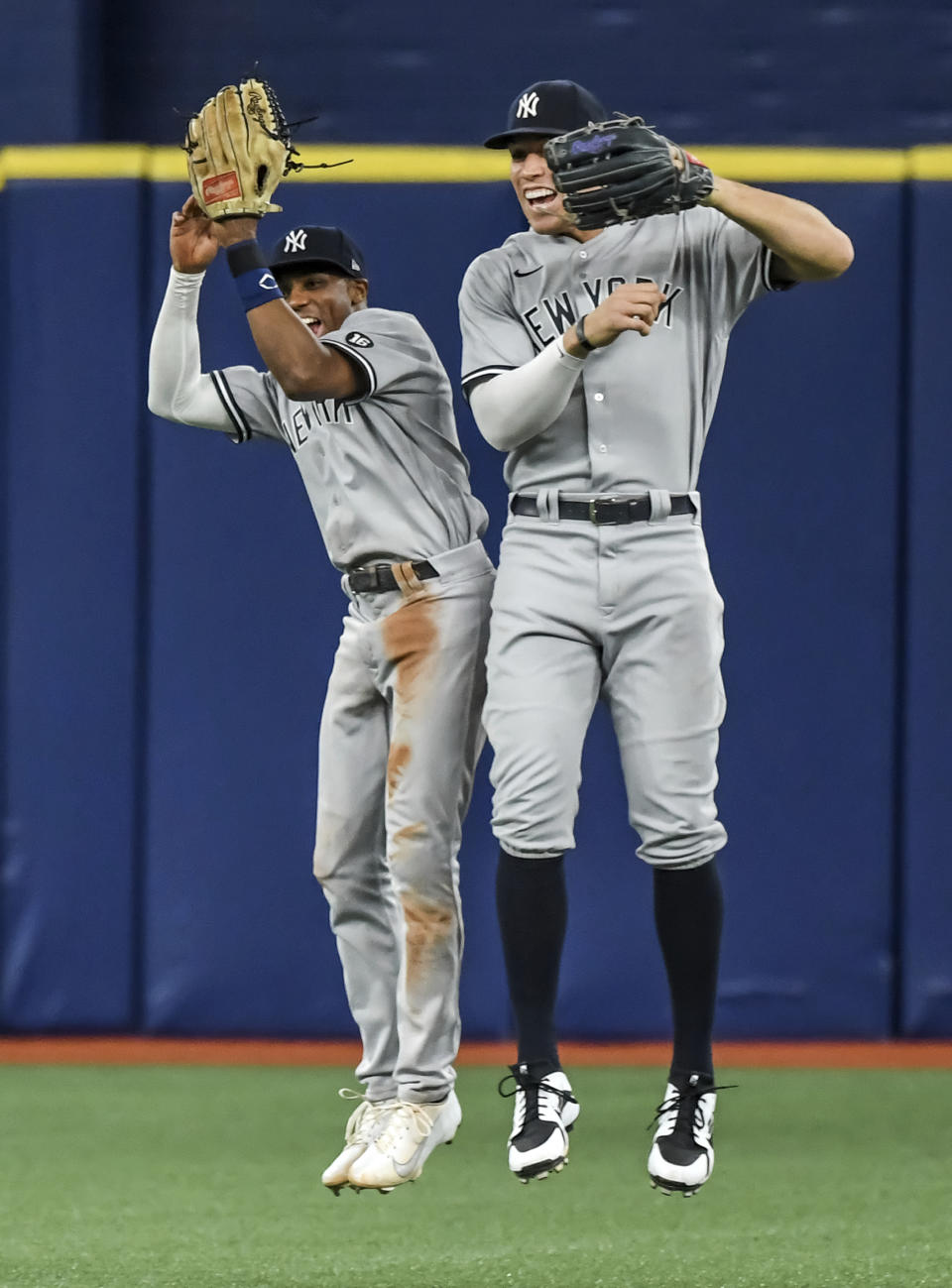 New York Yankees outfielders Greg Allen, left, and Aaron Judge celebrate the team's 4-3 win over the Tampa Bay Rays in a baseball game Tuesday, July 27, 2021, in St. Petersburg, Fla. (AP Photo/Steve Nesius)
