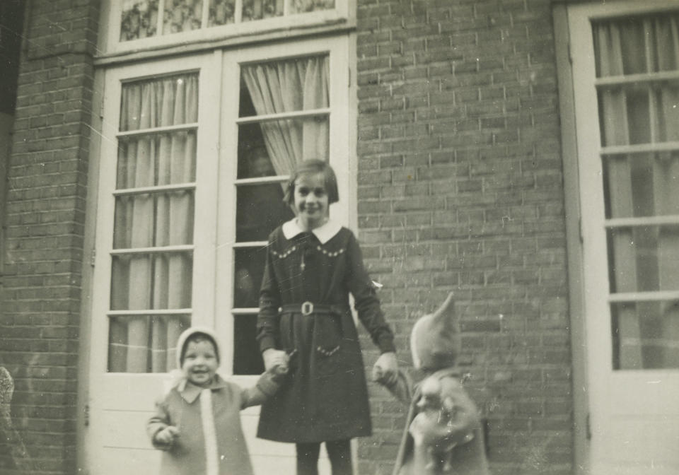 In this 1940 photo provided by the Anne Frank House Amsterdam on Tuesday, Feb. 4, 2014, Toosje Kupers, centre, poses with two girls in Amsterdam. Shortly before Anne Frank and her family went into hiding from the Nazis, she gave away some of her toys to non-Jewish neighborhood girlfriend Toosje Kupers for safekeeping. The toys have now been recovered and Anne's tin of marbles will go on display for the first time this week at an art gallery in Rotterdam, the Anne Frank House Museum says. (AP Photo/Anne Frank House Amsterdam/Toosje Kupers photo collection)