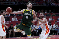 Matthew Dellavedova of Australia tries to pass the ball over Rudy Fernandez of Spain during their semifinals match for the FIBA Basketball World Cup at the Cadillac Arena in Beijing, Saturday, Sept. 13, 2019. (AP Photo/Andy Wong)