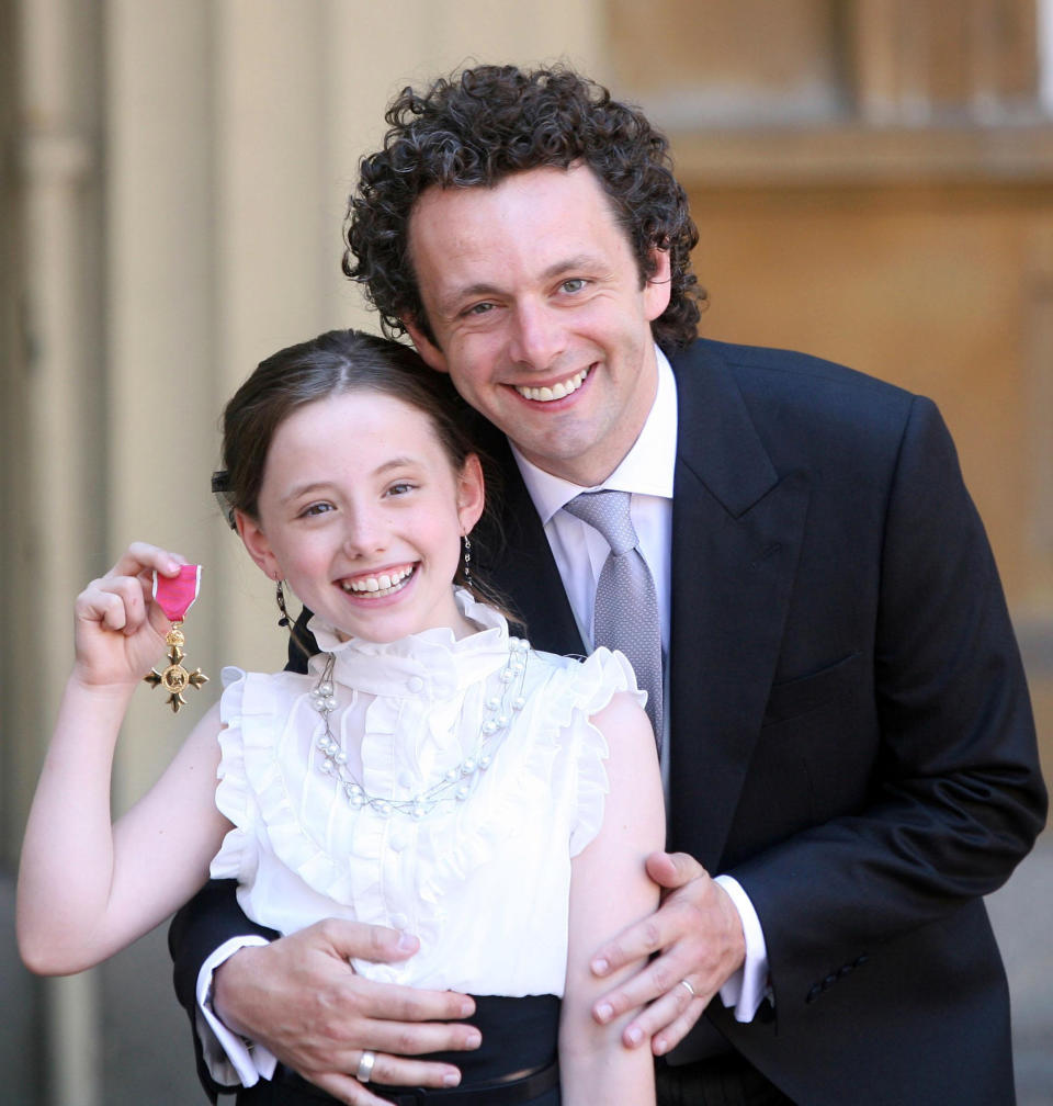 Actor Michael Sheen and daughter Lily with the OBE he received earlier from Queen Elizabeth II during investitures at Buckingham Palace.