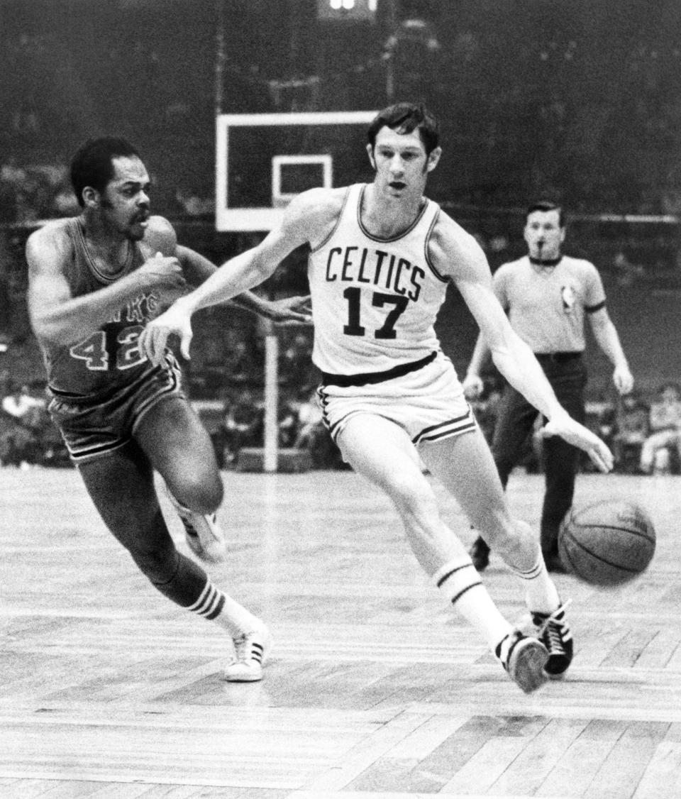 FILE - In this Jan. 8, 1970 file photo, Boston Celtics' John Havlicek (17) protects the ball with his body from Atlanta Hawks' Walt Hazzard (42) during an NBA basketball game in Boston. The Boston Celtics say Hall of Famer John Havlicek, whose steal of Hal Green’s inbounds pass in the final seconds of the 1965 Eastern Conference finals against the Philadelphia 76ers remains one of the most famous plays in NBA history, has died. The team says Havlicek died Thursday, April 25, 2019 at age 79. (AP Photo/File)
