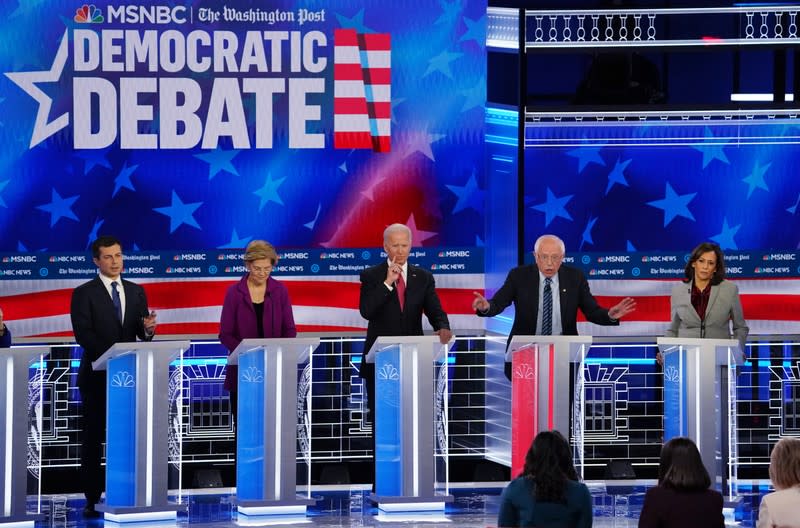 Democratic U.S. presidential candidates Buttigieg, Warren, Biden and Harris listen as Senator Bernie Sanders speaks during their fifth 2020 campaign debate at the Tyler Perry Studios in Atlanta