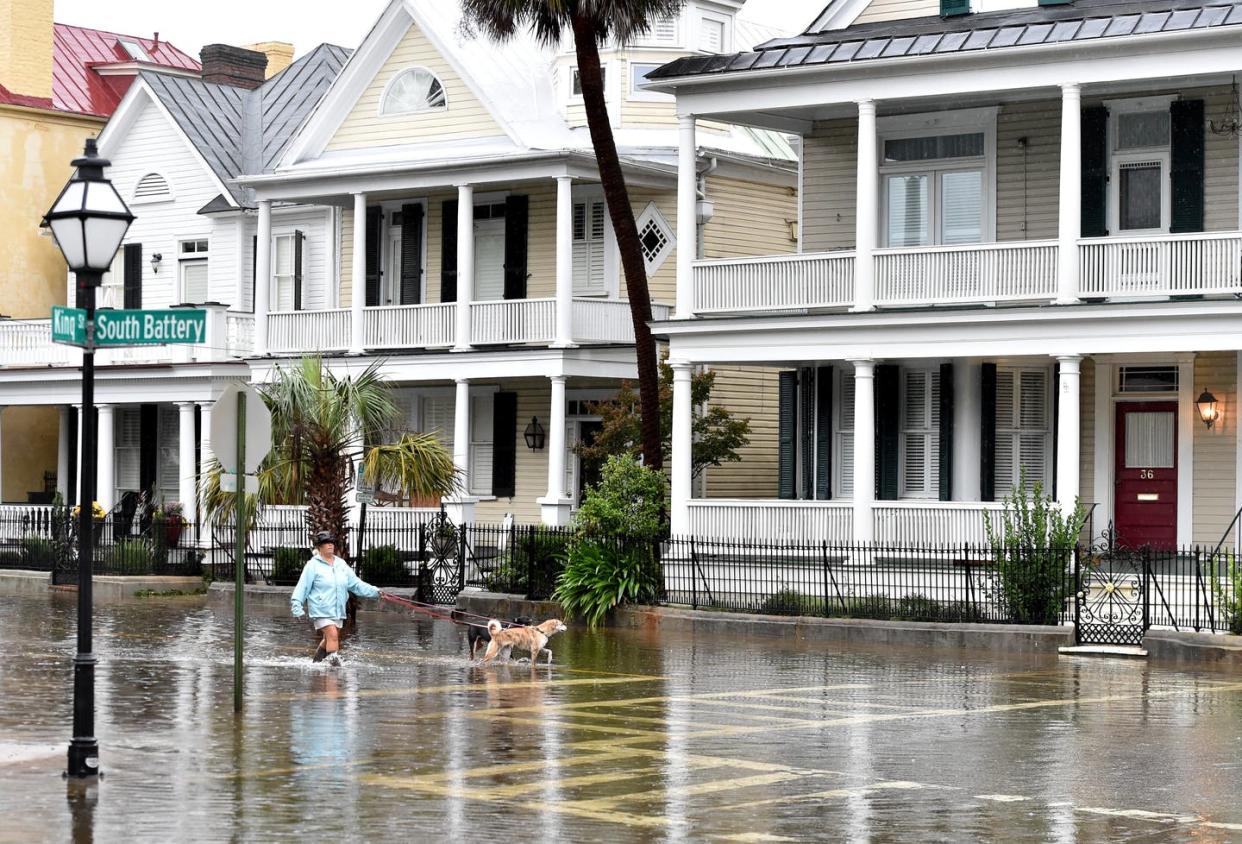 <span class="caption">Storms hitting at high tide can quickly flood streets.</span> <span class="attribution"><a class="link " href="https://www.gettyimages.com/detail/news-photo/local-resident-walks-her-dogs-on-a-flooded-street-in-news-photo/491275438" rel="nofollow noopener" target="_blank" data-ylk="slk:Mladen Antonov/AFP via Getty Image;elm:context_link;itc:0;sec:content-canvas">Mladen Antonov/AFP via Getty Image</a></span>