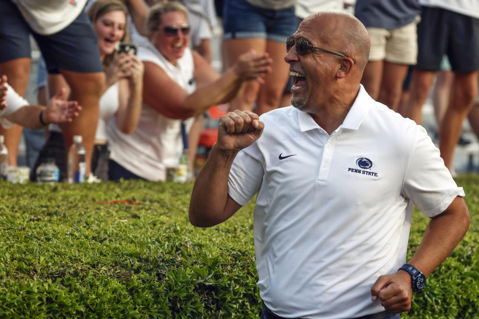 Penn State head coach James Franklin celebrates with fans after their victory over Auburn in an NCAA college football game, Saturday, Sept. 17, 2022, in Auburn, Ala. (AP Photo/Butch Dill)