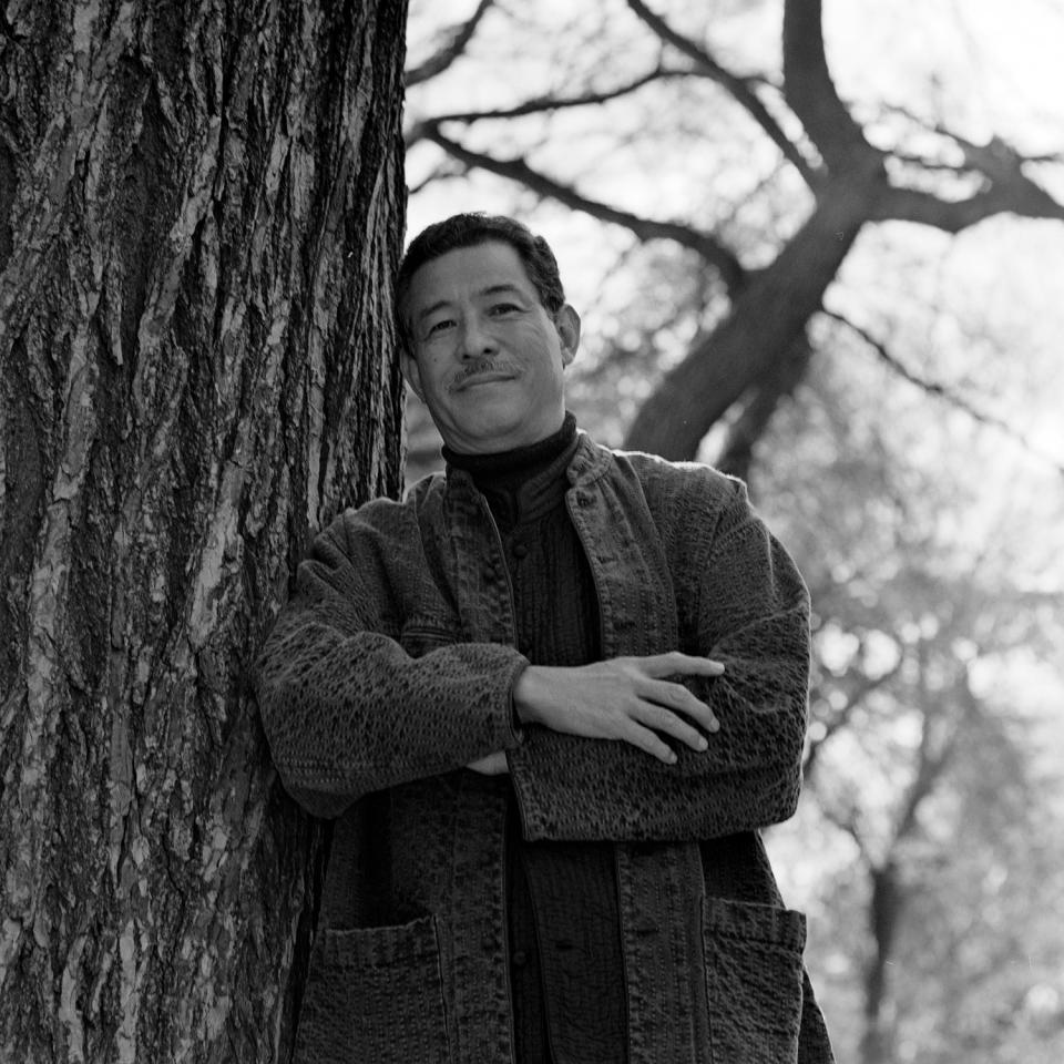 Designer Issey Miyake in New York’s Central Park, 1996. - Credit: Robert Mitra/WWD