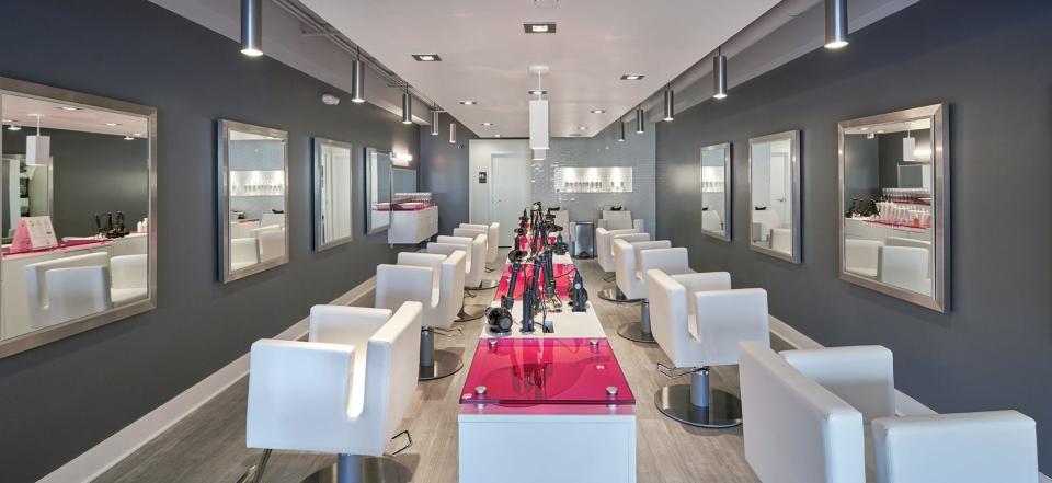 The inside of a Blo Blow Dry Bar in Wilmington, North Carolina, shows eight drying stations.