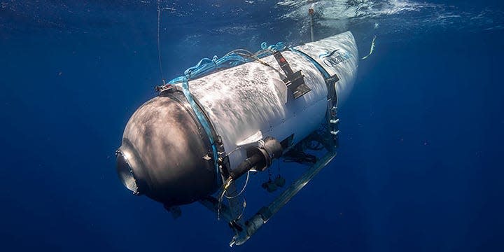 A side view of the Titan submersible in water.
