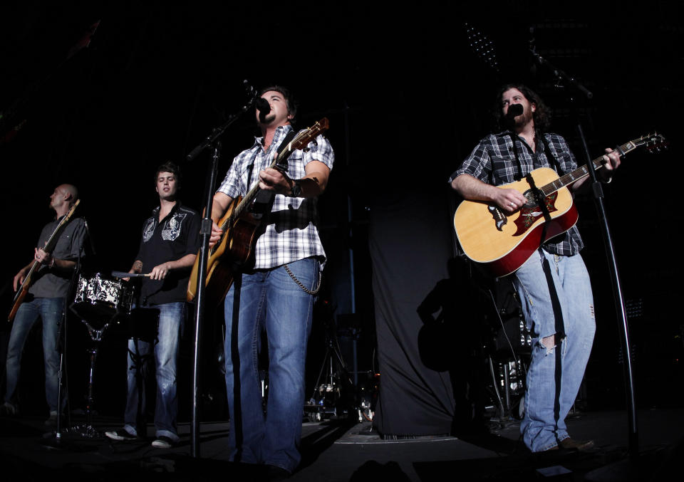 FILE - In this June 12, 2011, file photo, Eli Young Band performs during the CMA Fan Fest in Nashville, Tenn. Count the guys in Rascal Flatts among the fans of “Crazy Girl,” the song that took the Eli Young Band to the top of the country songs chart and earned the Texas quartet three nominations at the Academy of Country Music on Sunday. The veteran trio has tapped the new act for its “American Band” tour later this year and guitarist Joe Don Rooney recently raved of lead singer Mike Eli’s performance on the song. (AP Photo/Wade Payne, File)