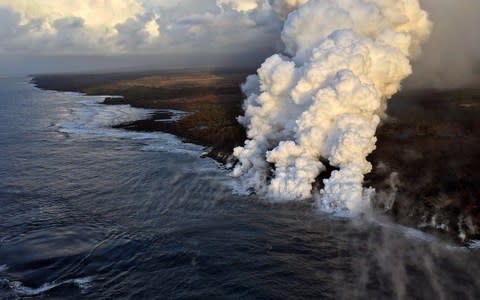 Lava pours into the sea on the south margin of the fissure 8 flow of the K?lauea volcano - Credit: AFP