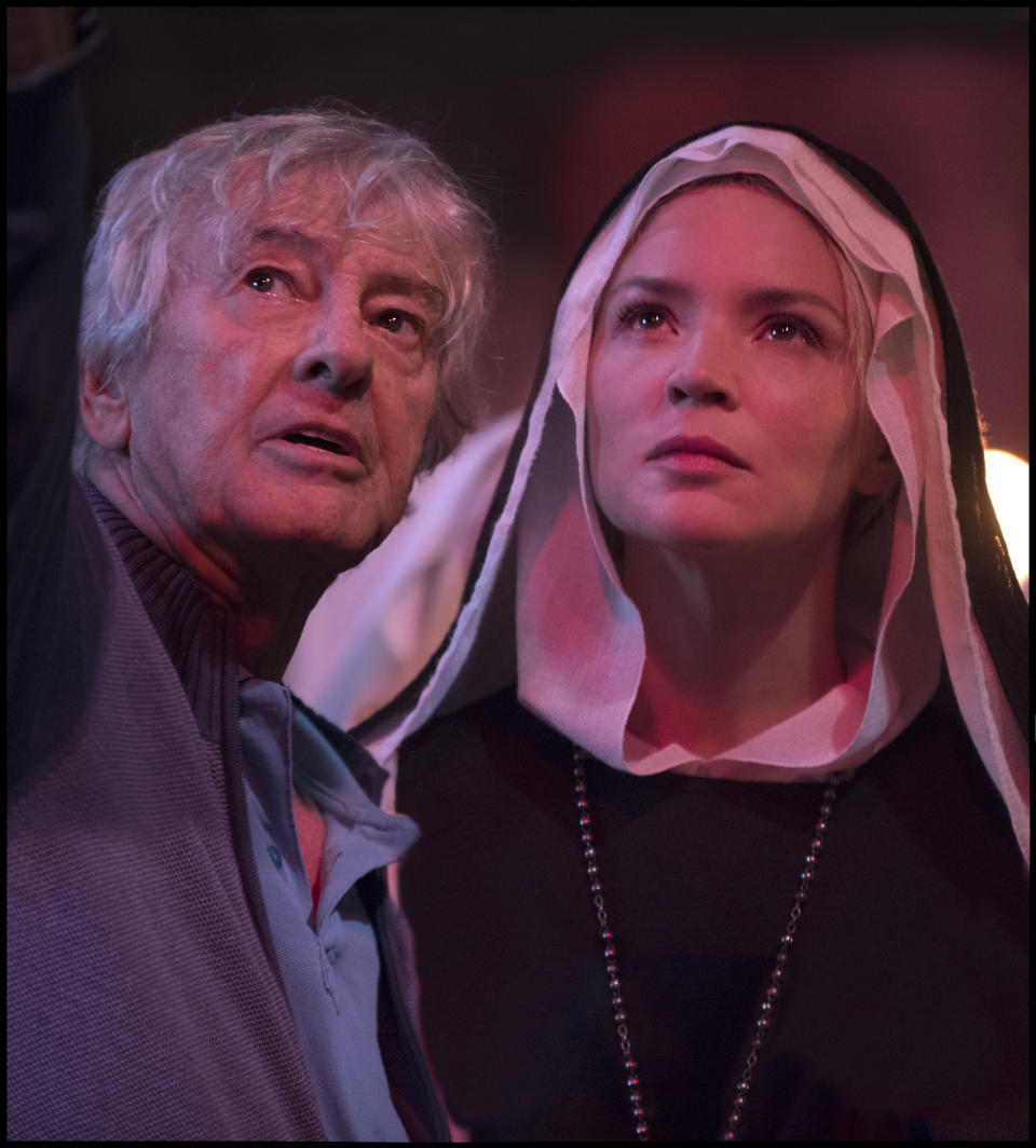 This image released by IFC Films shows director Paul Verhoeven, left, and Virginie Efira on the set of "Benedetta." (IFC Films via AP)